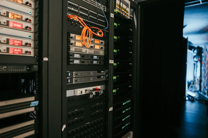 Rows of network and server equipment mounted in racks in a data center.